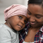 mother-of-african-descent-cuddles-her-child-who-has-cancer